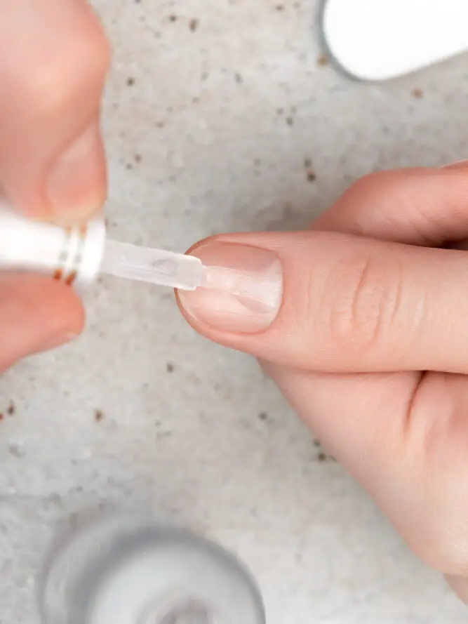 Applying Cuticle oil on nails 