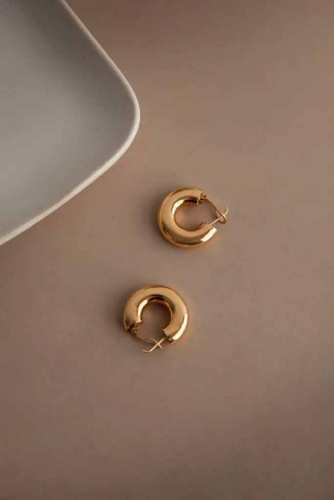 flat lay aesthetic golden earrings arrangement